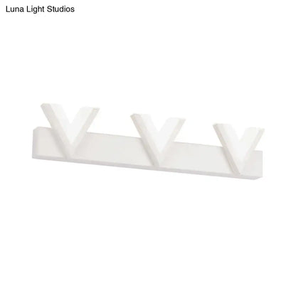White minimalist wall-mounted coat rack with three v-shaped hooks complementing a modern warm white led vanity light
