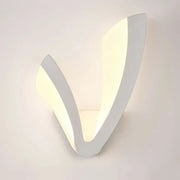 Modern v shaped white wall mounted light with sleek minimalist design providing warm white ambient bedroom lighting