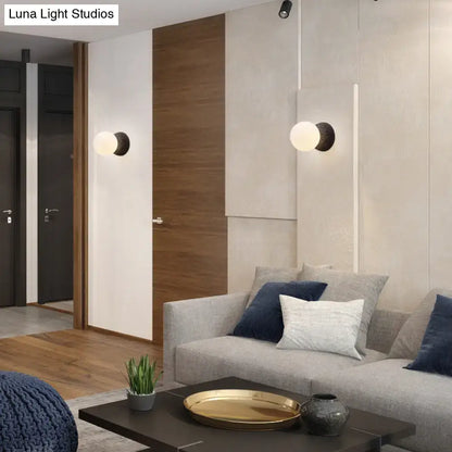Modern volcanic stone wall lamp with matte black bulb base and frosted white glass globes for living room