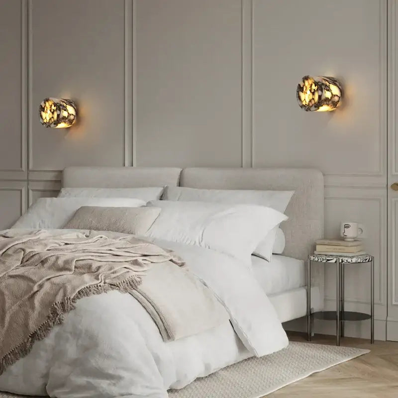 Modern wabi sabi black and cream resin led wall lamp with warm amber glowing mosaic textured finish for bedroom lighting