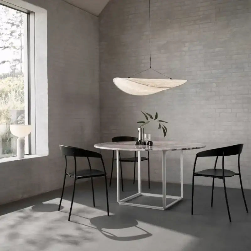 Modern wabi sabi white japanese style chandelier with sleek curved design hanging above dining table decorbites japanese style