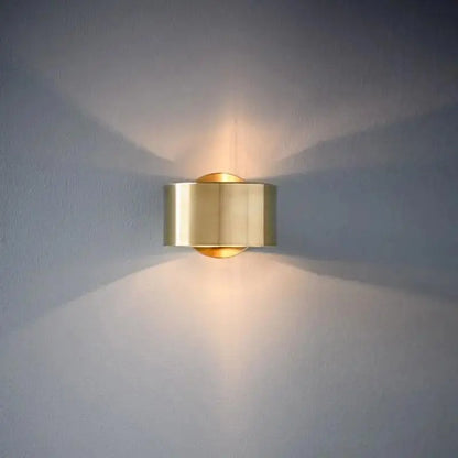 Modern wall lamp featuring a sleek brass cylindrical design in black gold for stylish modern wall lighting