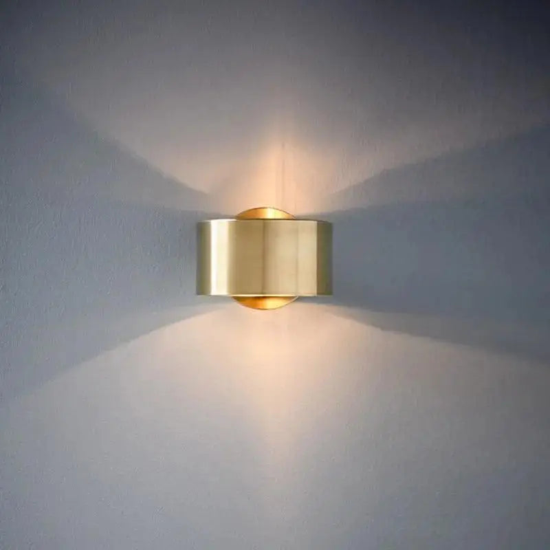 Modern wall lamp featuring a sleek brass cylindrical design in black gold for stylish modern wall lighting
