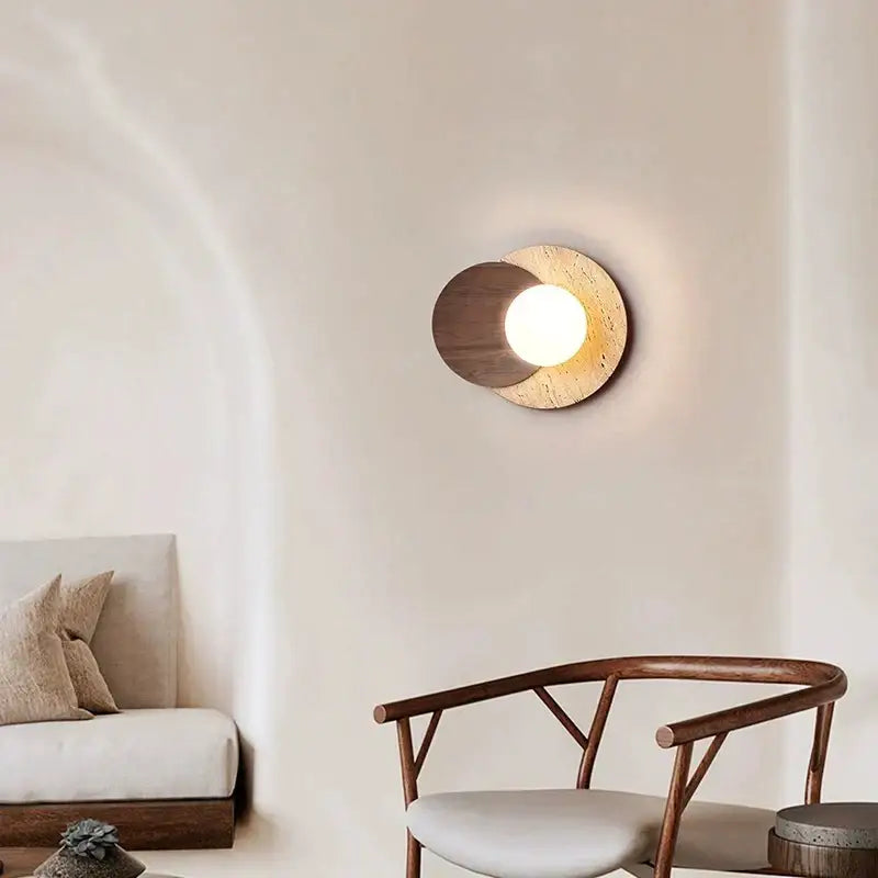 Modern walnut and cork led wall lamp with circular design featuring dark wood and textured beige stone around warm bulb