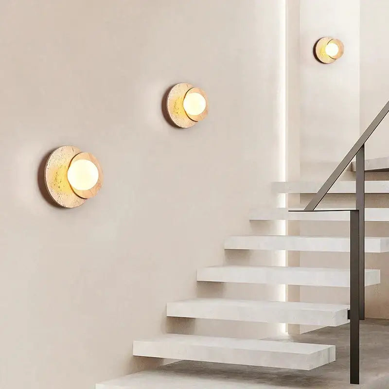 Modern walnut and cork led wall lamp featuring circular sconces with warm textured stone finish and gold accents