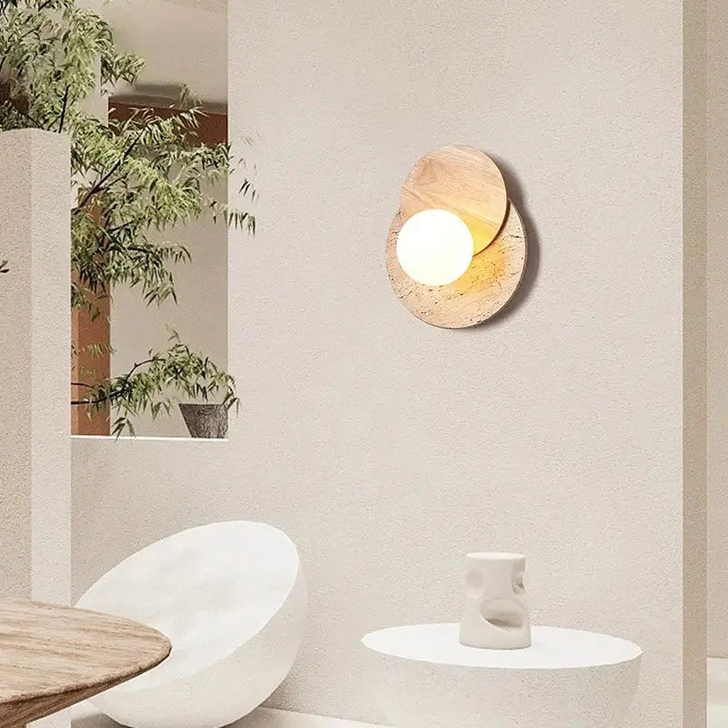 Modern walnut and cork led wall lamp with warm glowing circular light in overlapping natural wood toned stone discs