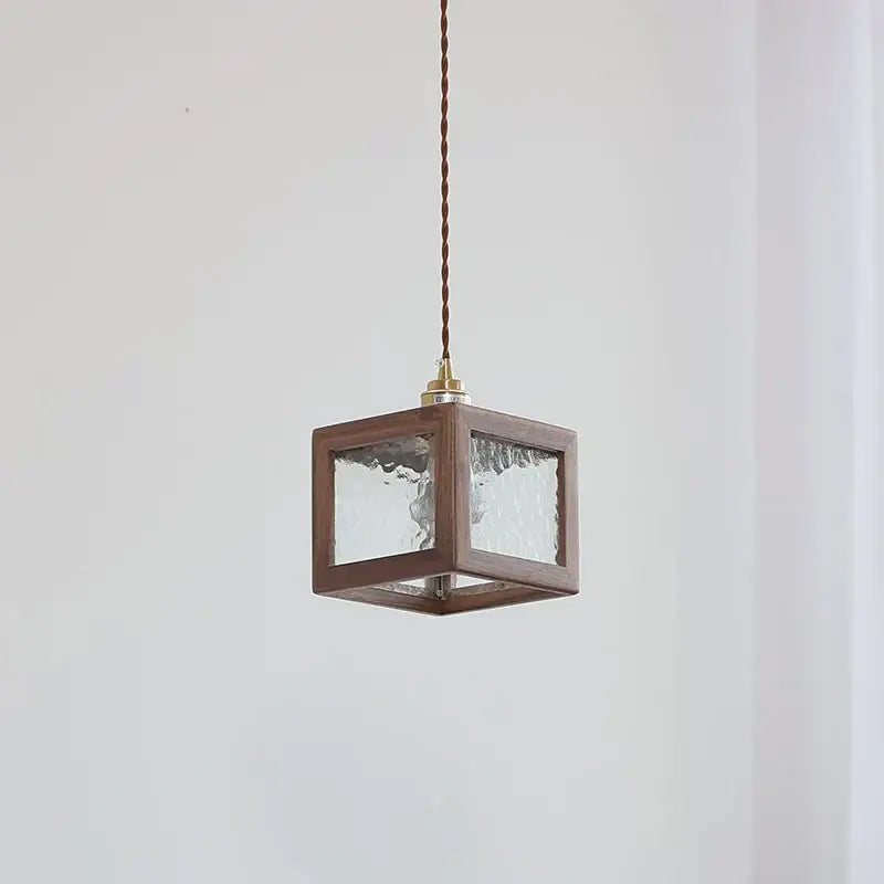 Modern walnut wood pendant light with clear glass textured panels and brass fixture for dining room lighting