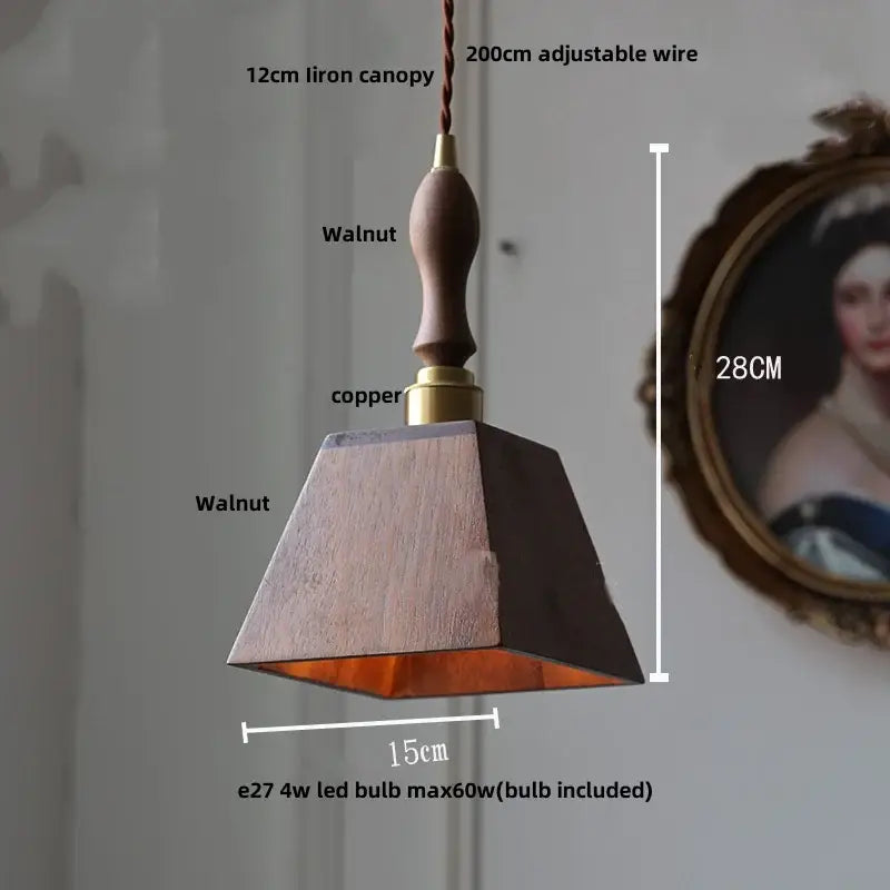 Modern walnut wood pendant light with clear glass cube, walnut finish, copper accent, and adjustable wire suspension