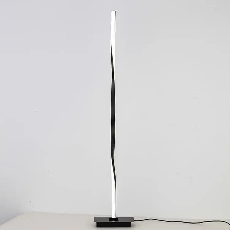 A sleek modern decorbites dimmable led floor lamp with twisted silver and black design for living room lighting