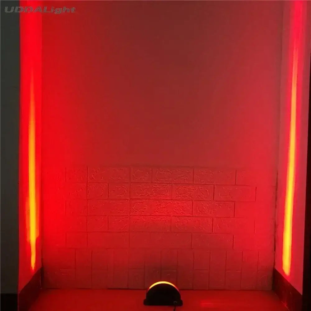 A sleek black led spotlight with a curved dome head casting red and orange beams for decorbites led window lighting decor