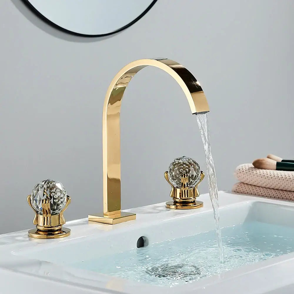 Modern waterfall dual handle gold basin faucet with crystal globe handles and flowing waterfall spout decorbites dual handle gold