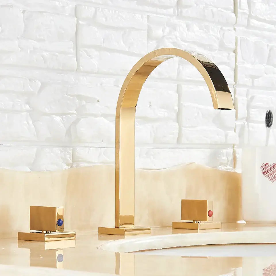 Modern waterfall dual handle gold basin faucet with sleek arched spout and decorbites dual handle gold accents