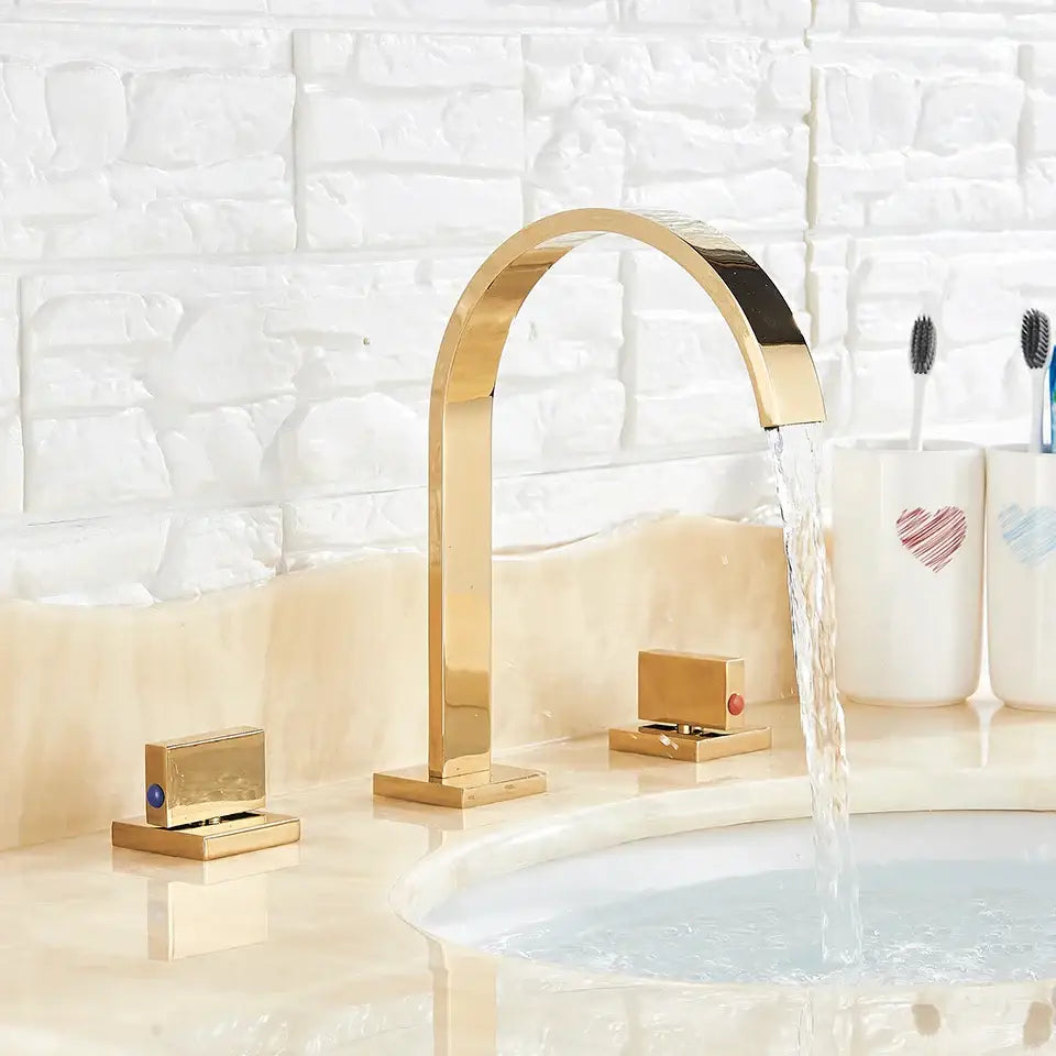 Modern waterfall dual handle gold basin faucet with sleek gold-toned arched design and flowing water stream decorbites dual handle