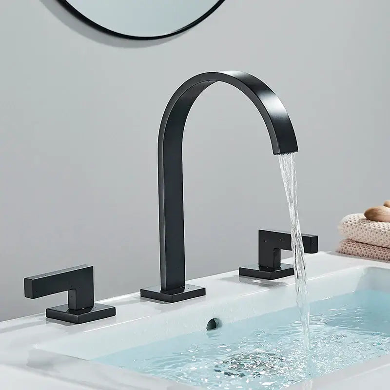 Black matte basin faucet with curved spout and square handles featuring decorbites dual handle gold design