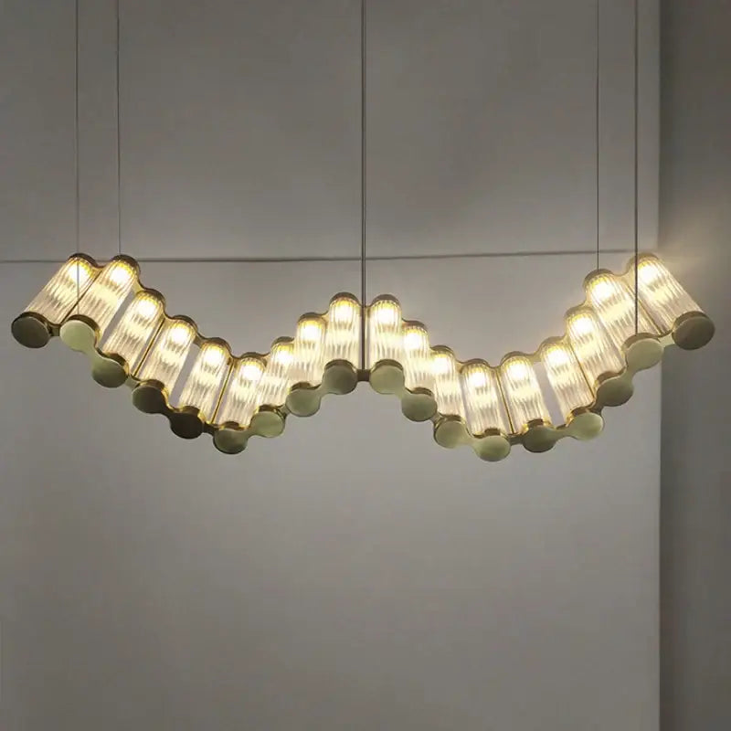 Curved modern decorbites golden chandelier with translucent ribbed glass tubes suspended in undulating pattern for living room