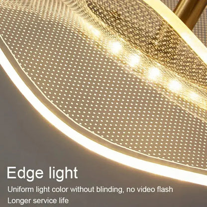 Modern wave glass gold led pendant with curved perforated metal shade and warm edge lighting for dining tables and living rooms