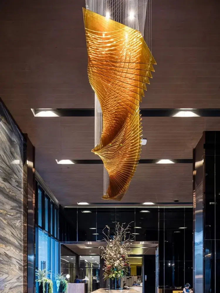 Modern wave golden designer chandelier with layered fan like segments for dining room decorbites designer chandelier