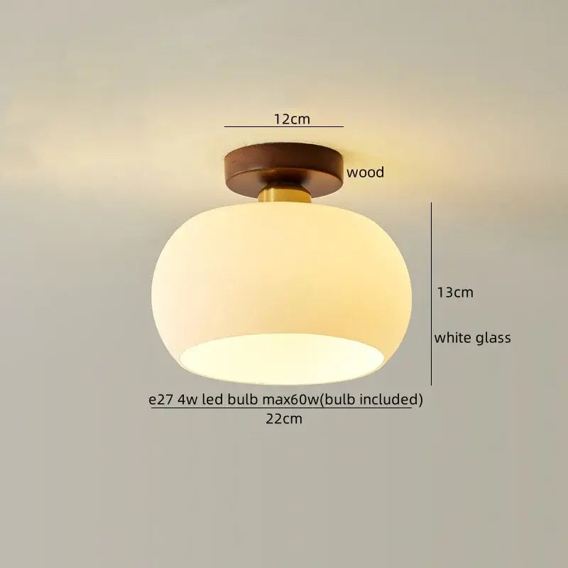 A warm ceiling lamp with a round white glass shade and wooden base featuring decorbites led wood design