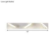 Modern white 3-light adjustable wall light fixture with three sleek angled circular led lights for bathroom use