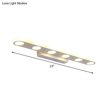 Modern white rectangular vanity wall light fixture with six circular led bulbs providing warm white light