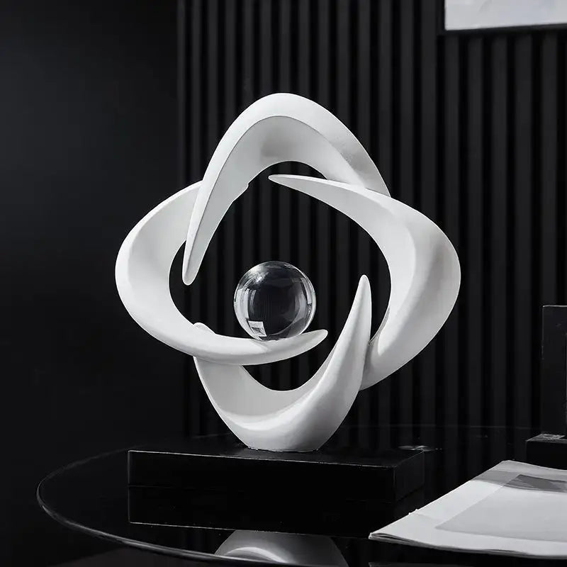 Modern white abstract resin sculpture figurine with flowing curves cradling a clear glass sphere for living room decorbites decor