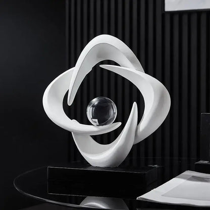 Modern white abstract resin sculpture figurine with flowing curves cradling a clear glass sphere for living room decorbites decor