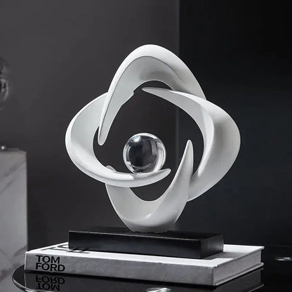 Modern white abstract resin sculpture figurine with flowing curves encircling glass sphere on black base decorbites abstract resin decor