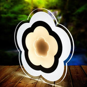 Modern white acrylic cloud led table lamp with sleek black accents emitting warm ambient light for bedroom use