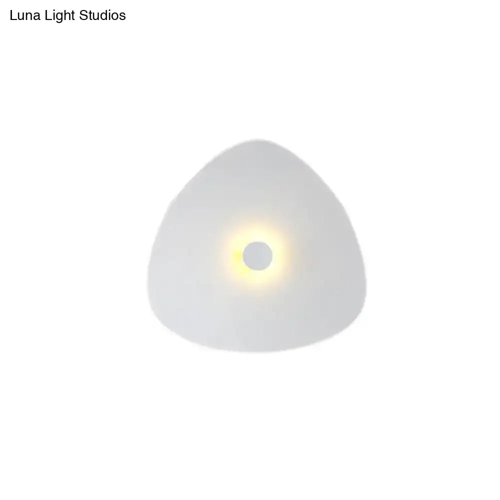 Modern white acrylic flaky sconce light with a sleek triangular design and soft glowing circular center for bedroom walls