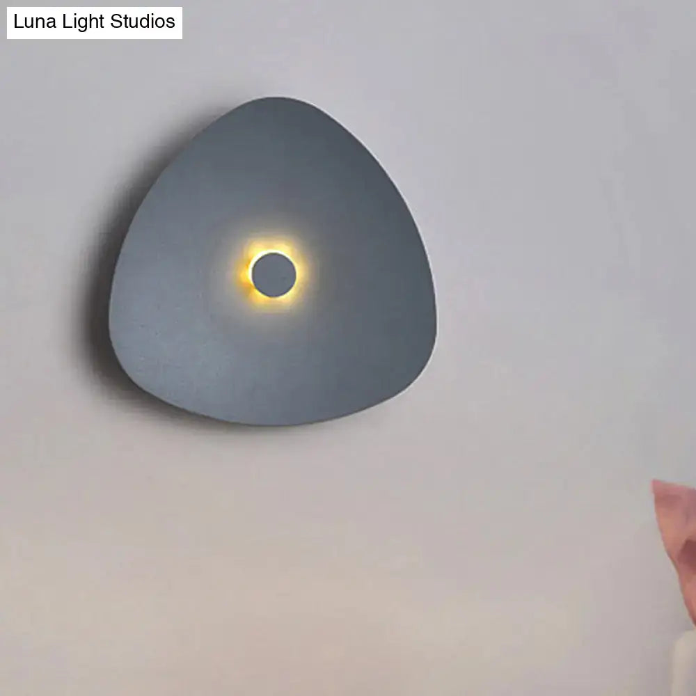 Modern white acrylic flaky sconce light bedroom wall fixture with sleek matte gray triangular sconce light emitting warm glow
