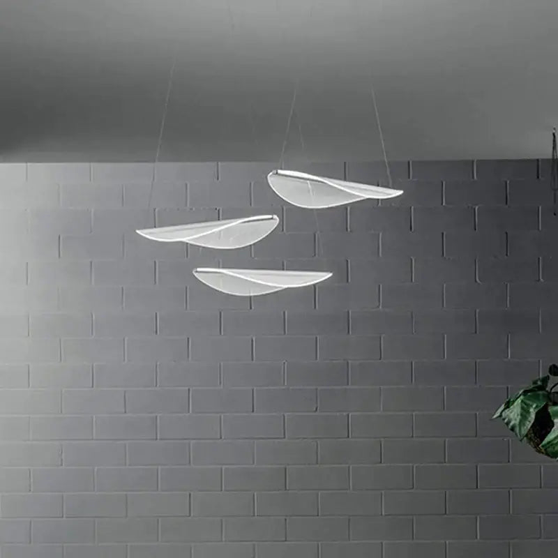 Modern white acrylic leaf pendant lights with translucent blades in a staggered arrangement for dining room decorbites acrylic leaf pendant