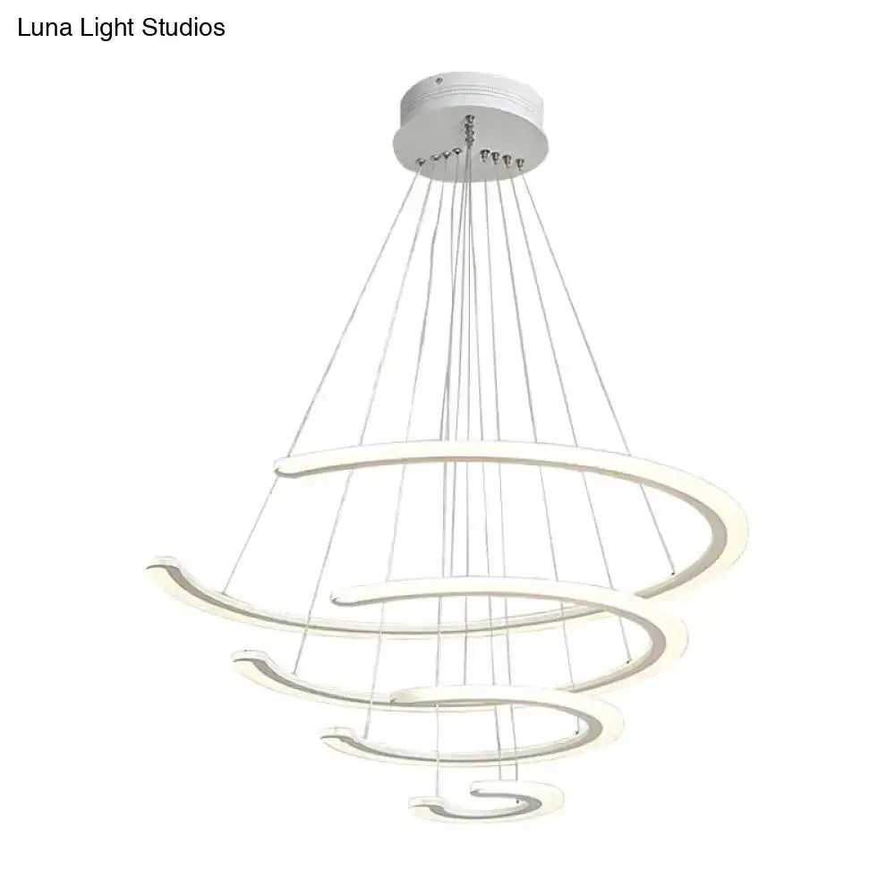 Modern white acrylic ring dining room chandelier with layered rings suspended by thin cables in warm white light