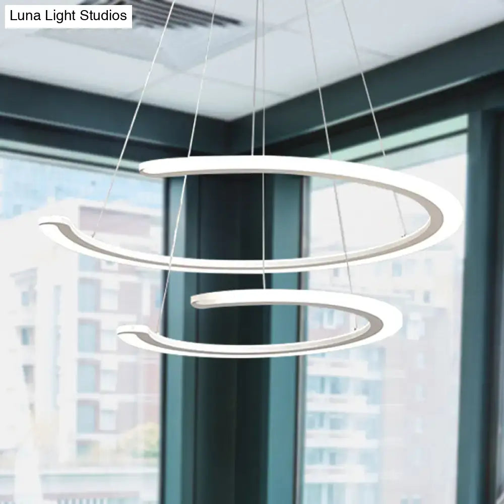 Modern white acrylic ring dining room chandelier with spiral pendant design in warm white natural light by DecorBites