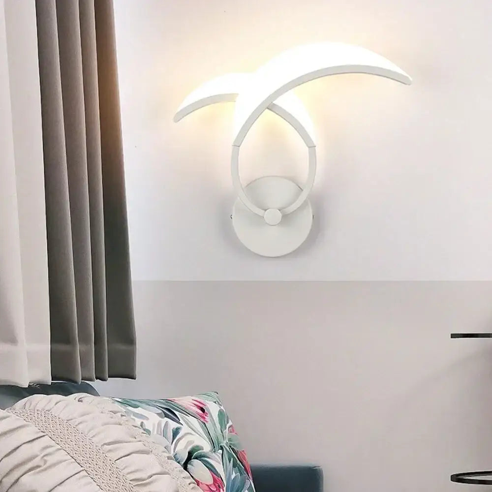 Modern white acrylic led wall sconce light with sleek curved arms emitting warm glow for bedroom corridor decorbites led wall