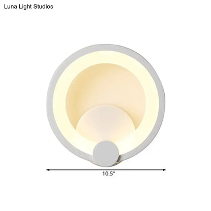 Modern white acrylic sconce light featuring circular matte white rings with soft warm led lighting for bedroom use