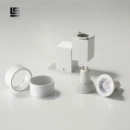 Modern white adjustable angle downlight with sleek design and metallic accents for living room spotlight fixture