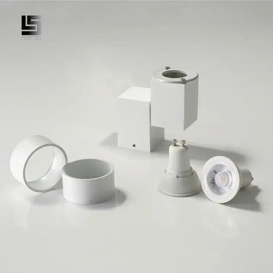 Modern white adjustable angle downlight with sleek design and metallic accents for living room spotlight fixture