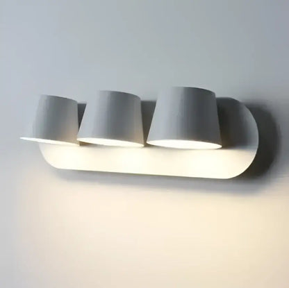 Modern white adjustable led wall lamps with three cylindrical shades mounted on wall for living room and bedroom use