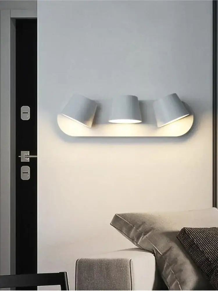 Modern white adjustable led wall lamps with three cylindrical lamp heads for bedroom and living room use
