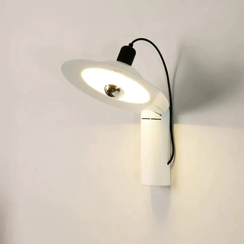 Modern white adjustable wall sconce with a curved arm and circular shade designed for bedroom reading lighting
