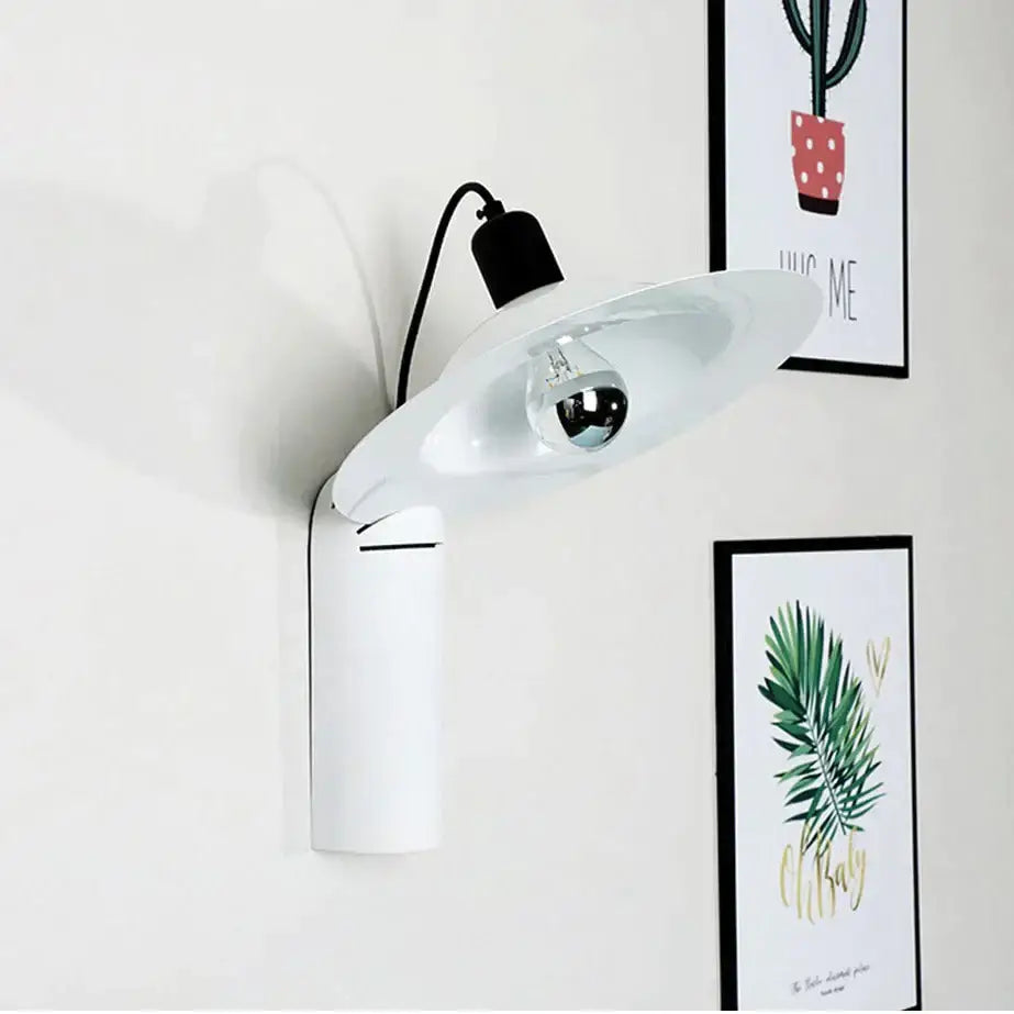 Modern white adjustable wall sconce with a sleek curved shade and visible bulb for bedroom reading use