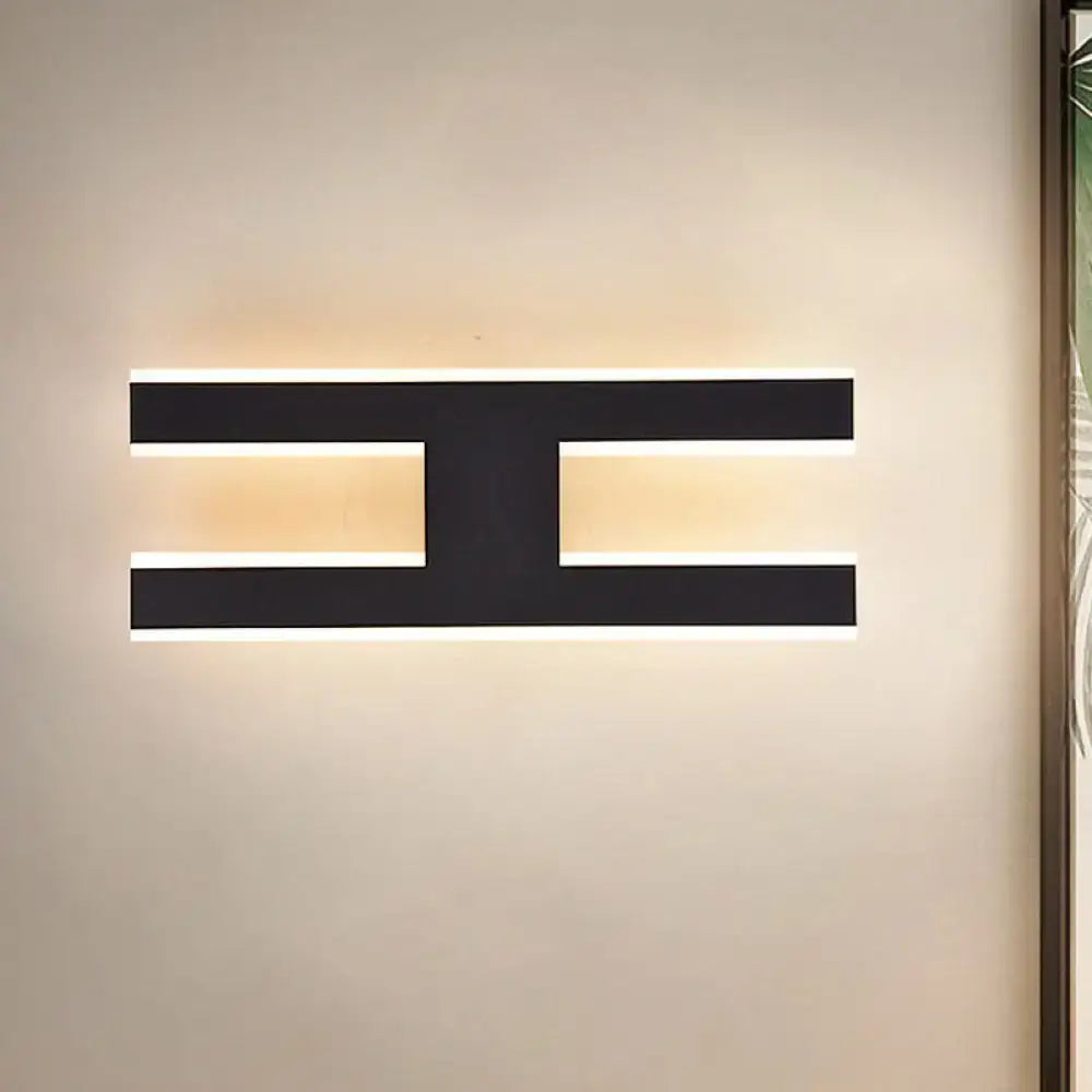 Modern white alphabet wall lamp with sleek geometric black led fixture and warm glow for 110v-120v use