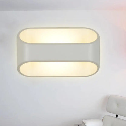 Modern white aluminum led wall sconce with two horizontal oval panels and frosted glass diffusers emitting warm glow