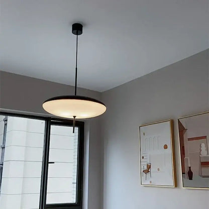 Modern white and black acrylic pendant light with a circular glowing diffuser for kitchen decor featuring decorbites black acrylic pendant