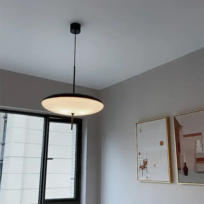 Modern white and black acrylic pendant light with a circular glowing diffuser for kitchen decor featuring decorbites black acrylic pendant