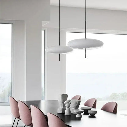 Modern white disc-shaped pendant light with sleek black acrylic cords for kitchen decorbites black acrylic pendant decor