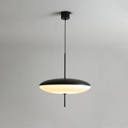 Black acrylic pendant light with sleek disc-shaped shade and warm glow for modern white and black kitchen decorbites decor