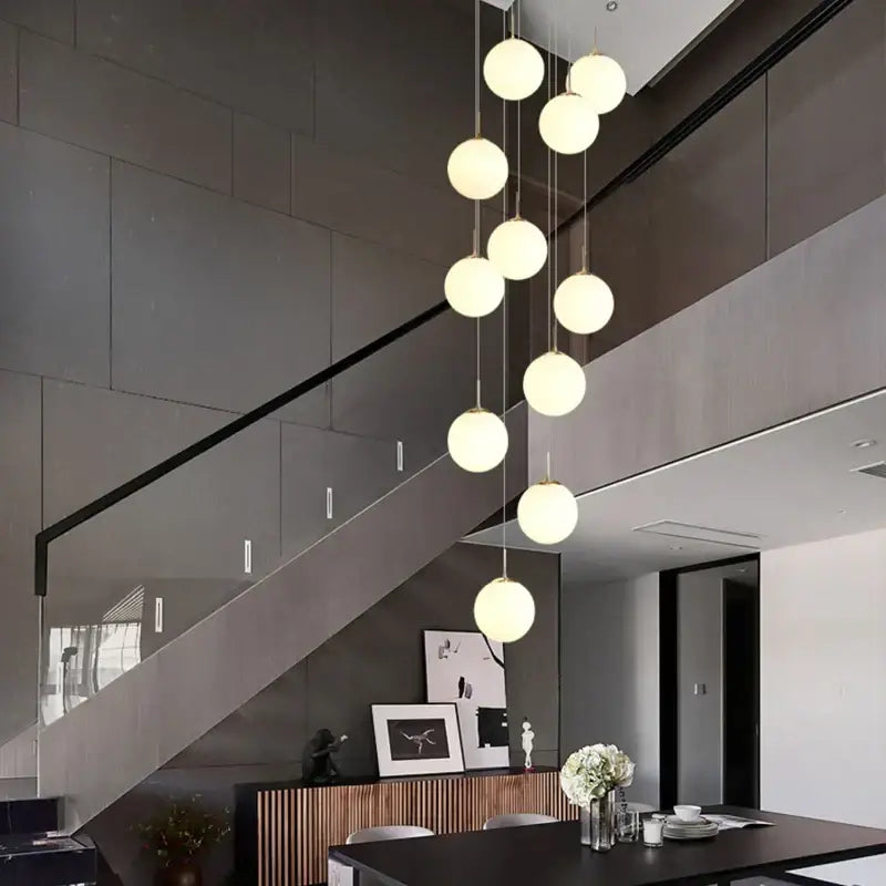 Modern white and black cream glass ball chandelier with cascading spherical bulbs for staircase decorbites cream glass decor