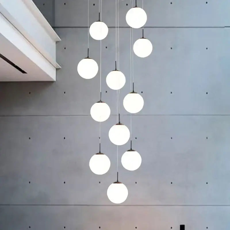 Modern white and black decorbites cream glass ball chandelier with cascading spherical pendant lights for staircase decor