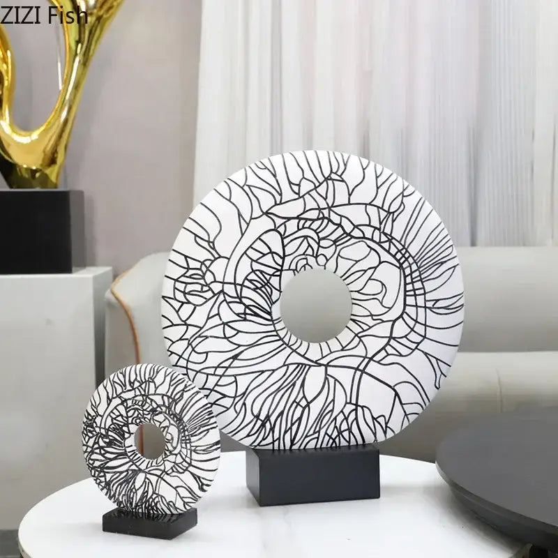 Modern white and black floral decorbites circle ornament featuring intricate black line art on a sleek black base